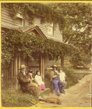 [Group of people sitting in front of a house.] 1858?-1890?