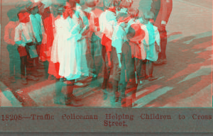 Traffic Policeman Helping Children to Cross the Street. [ca. 1900]