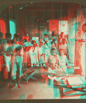 Native Jamaican School Children reciting in their Little Rough School House. 1904