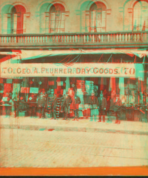 [Geo. A. Plummer Dry goods store showing men in front and goods visible.] 1859?-1885?