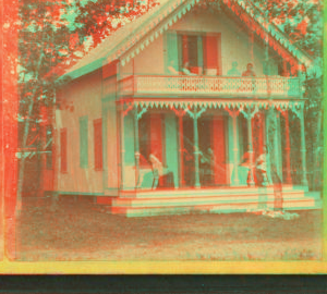 [People on the porch and balcony of a cottage.] 1865?-1885?