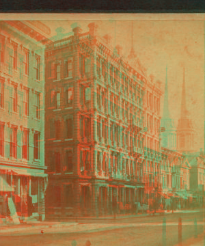 [View of a commercial street, including a church.] 1865?-1885?