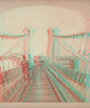 Niagara Suspension Bridge. [Man in a top hat standing on railroad tracks.] [1859?-1885?] [ca. 1860]