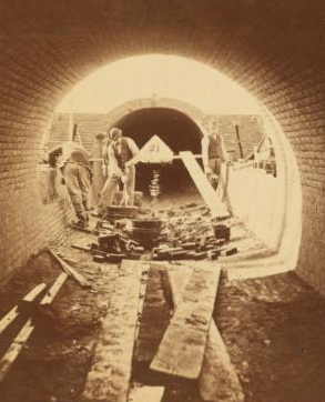 Sudbury River Conduit, B.W.W., div. 4, sec. 15, Nov. 13, 1876. View from inside of conduit; brickmasons at work in the east terminal chamber of bridge. 1876?-1878?