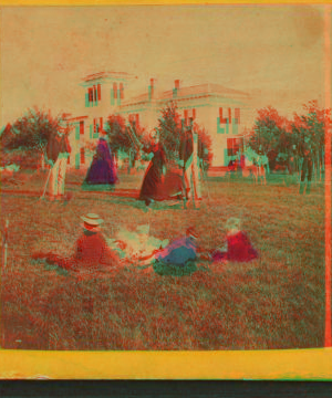 [View of group playing croquet, man holding woman's skirt aside for her.] 1859?-1885?