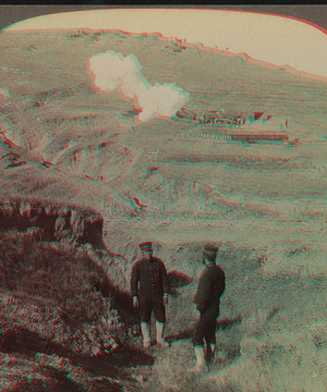 Great Japanese siege guns firing over the hills into Port Arthur