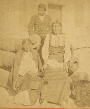 Medicine Water, and wife Mocchi, with Romeo, the Cheyenne interpreter, in native costume, confined in Fort Marion,  St. Augustine, Florida. 1875-1878 1868?-1890?