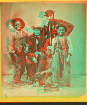 Shoe Blacks. [Studio portrait of three young shoe shiners and their customers.] 1868?-1900?