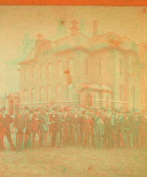 [Group portrait in front of an office building.] 1867?-1890?