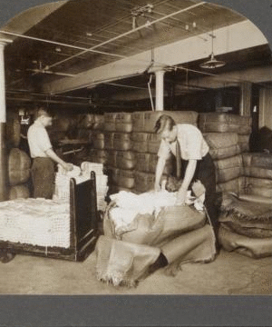 Opening bales of raw silk as it arrives from China, Japan and Italy. Silk industry (reeled silk), South Manchester, Conn., U.S.A. c1914 1914