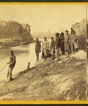 Dutch Gap canal and group of soldiers. Taken after the bank was blown out. On the extreme end a portion of the bank remains, which forms a profile, which the soldiers call Jeff. Davis. 1861-1865