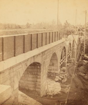 Sudbury River Conduit, B.W.W., div. 4, sec. 15, Nov. 13, 1876. View taken below bridge from Newton side, showing the six completed arches. 1876 1876?-1878?