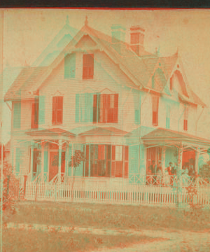 The Rectory. [Showing a group of adults and children on the porch of "Rectory"] 1865?-1905?