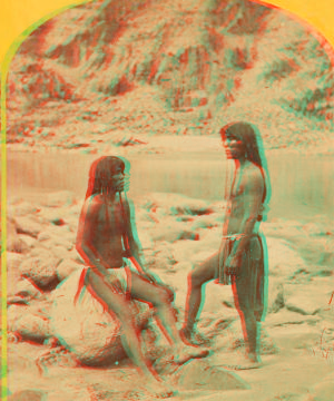 Types of Mojave Indians. [Two Mojave men pose on rocks in front of the river.] 1871