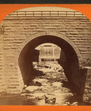 Down at water shops, seen through archway. 1865?-1885?