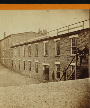 Tobacco warehouse on High St. Petersburgh, [sic], Va., used by the rebels as temporary prisons. View from the south side.