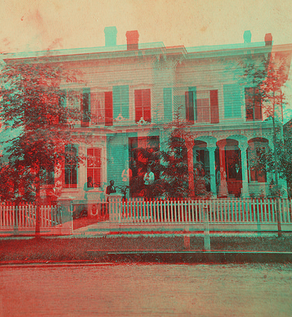 Family in front of two-story home