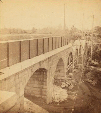 Sudbury River Conduit, B.W.W., div. 4, sec. 15, Nov. 13, 1876. View taken below bridge from Newton side, showing the six completed arches. 1876 1876?-1878?