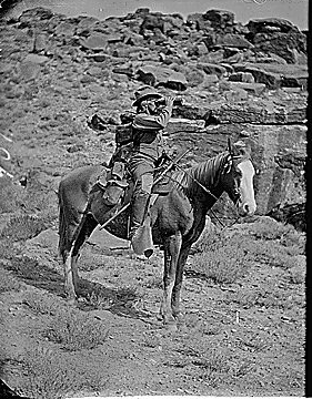 Prof. A.H. Thompson on his horse "Old Ute", looking through field glasses, about 1873. Old nos. 441, 468, 459, 661. See 663 also.