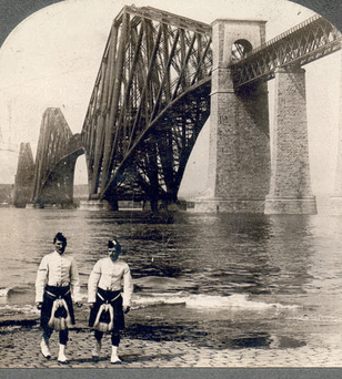 Highlanders in native costume at the great Forth Bridge, one and one-half miles long, spanning the Firth of Forth, Queensferry, Scotland