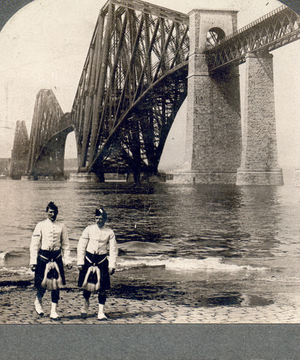 Highlanders in native costume at the great Forth Bridge, one and one-half miles long, spanning the Firth of Forth, Queensferry, Scotland