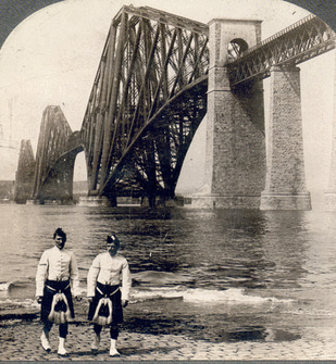 Highlanders in native costume at the great Forth Bridge, one and one-half miles long, spanning the Firth of Forth, Queensferry, Scotland