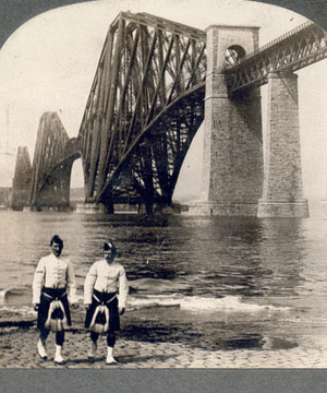 Highlanders in native costume at the great Forth Bridge, one and one-half miles long, spanning the Firth of Forth, Queensferry, Scotland