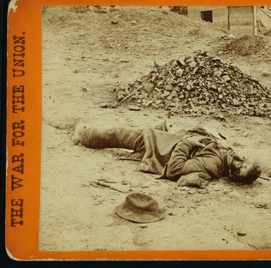 A rebel soldier, killed at the trenches before Petersburgh, [sic], the spots and marks on his face, are blood issuing from his mouth and nose. [Stereograph.]