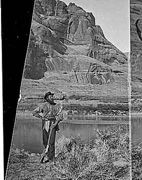 Glen Canyon. John F. Steward with his gun, pick and shoulder bag (map case?) and wearing the usual wide brim felt hat. Old nos. 307, 404, 414, 609.