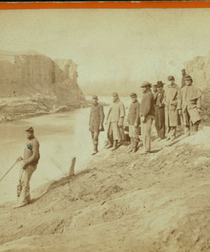 Dutch Gap canal and group of soldiers. Taken after the bank was blown out. On the extreme end a portion of the bank remains, which forms a profile, which the soldiers call Jeff Davis.