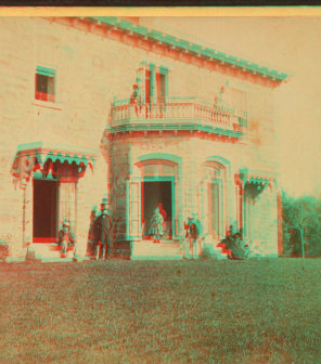 [Family posing in front and in the balcony of Stone House.] 1860?-1869?