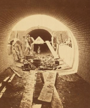 Sudbury River Conduit, B.W.W., div. 4, sec. 15, Nov. 13, 1876. View from inside of conduit; brickmasons at work in the east terminal chamber of bridge. 1876?-1878?