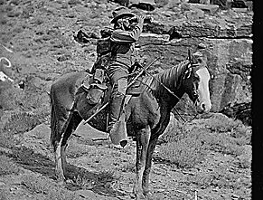 Prof. A.H. Thompson on his horse "Old Ute", looking through field glasses, about 1873. Old nos. 441, 468, 459, 661. See 663 also.