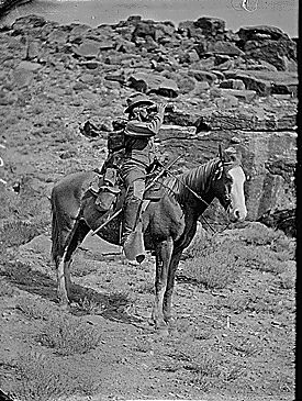 Prof. A.H. Thompson on his horse "Old Ute", looking through field glasses, about 1873. Old nos. 441, 468, 459, 661. See 663 also.