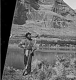 Glen Canyon. John F. Steward with his gun, pick and shoulder bag (map case?) and wearing the usual wide brim felt hat. Old nos. 307, 404, 414, 609.