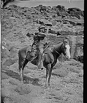 Prof. A.H. Thompson on his horse "Old Ute", looking through field glasses, about 1873. Old nos. 441, 468, 459, 661. See 663 also.