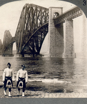 Highlanders in native costume at the great Forth Bridge, one and one-half miles long, spanning the Firth of Forth, Queensferry, Scotland