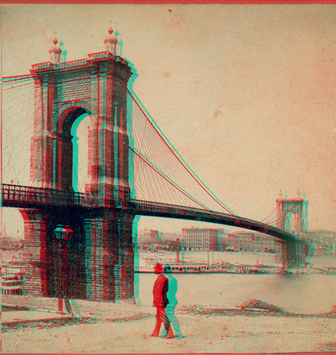 Cincinnati-Covington Bridge with pedestrian in foreground and buildings in background